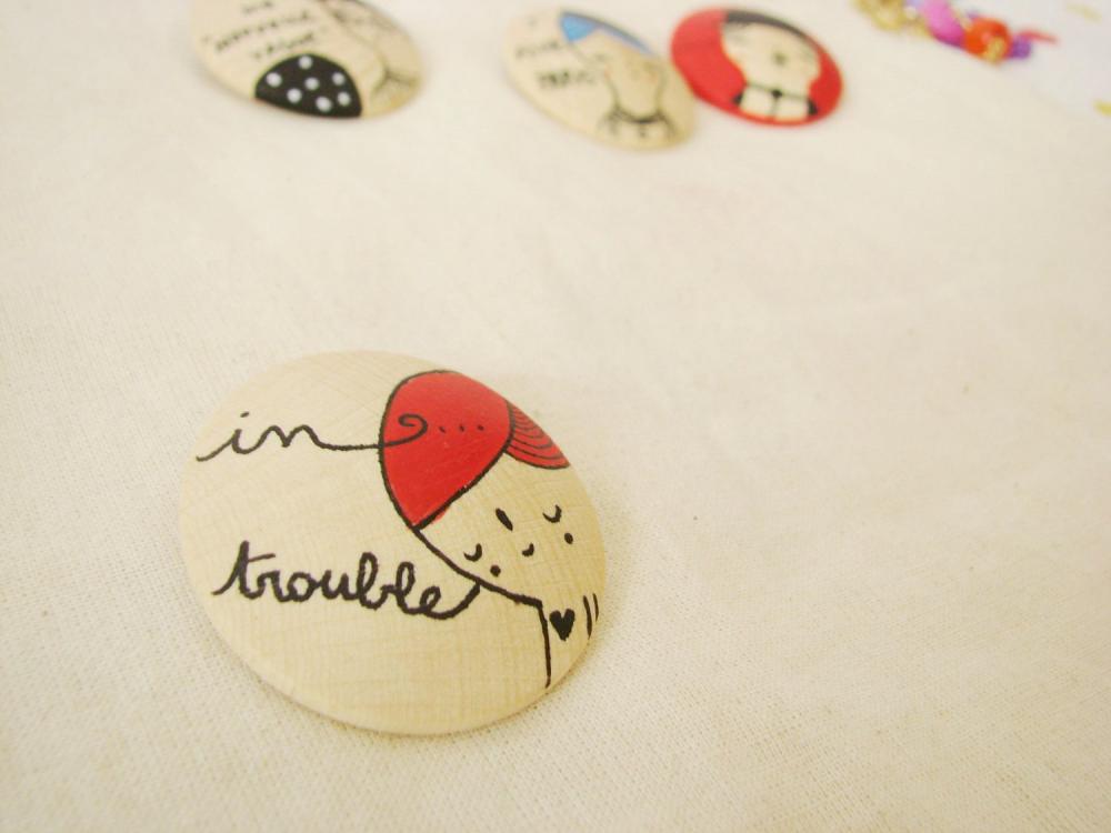 Hand painted wooden brooch In Trouble